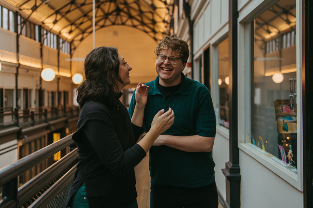 Engaged couple shares a laugh during downtown Nashville shoot