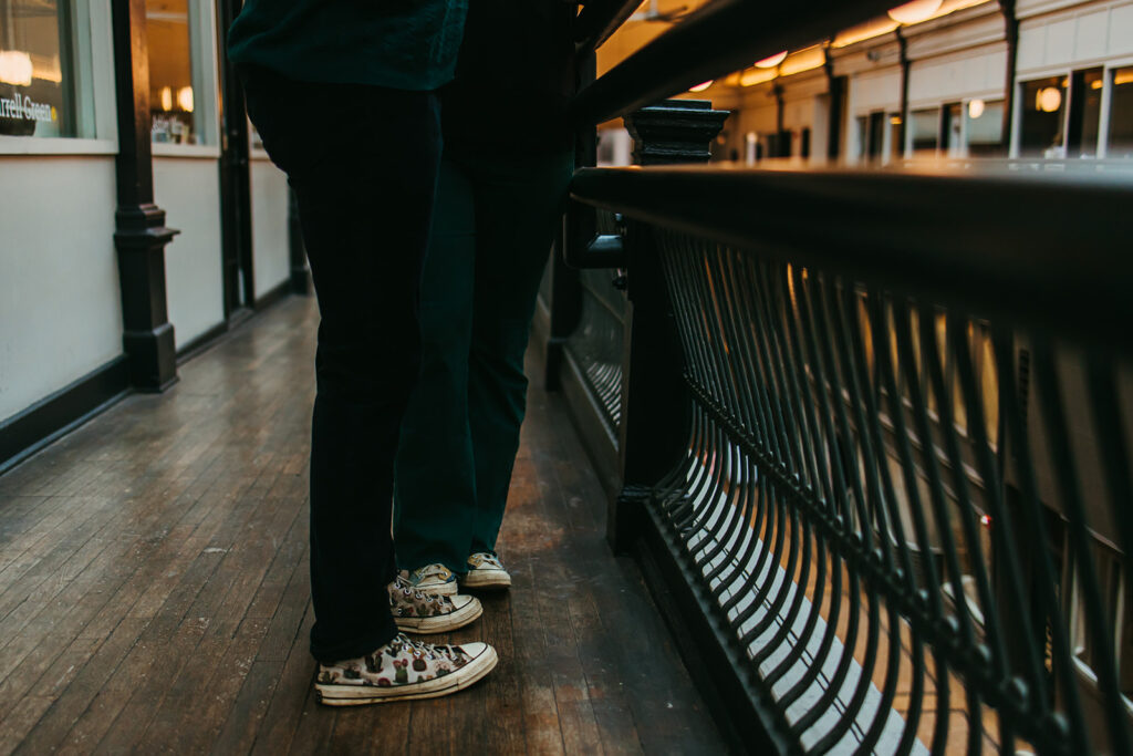 Couple wearing Converse walk through downtown Nashville