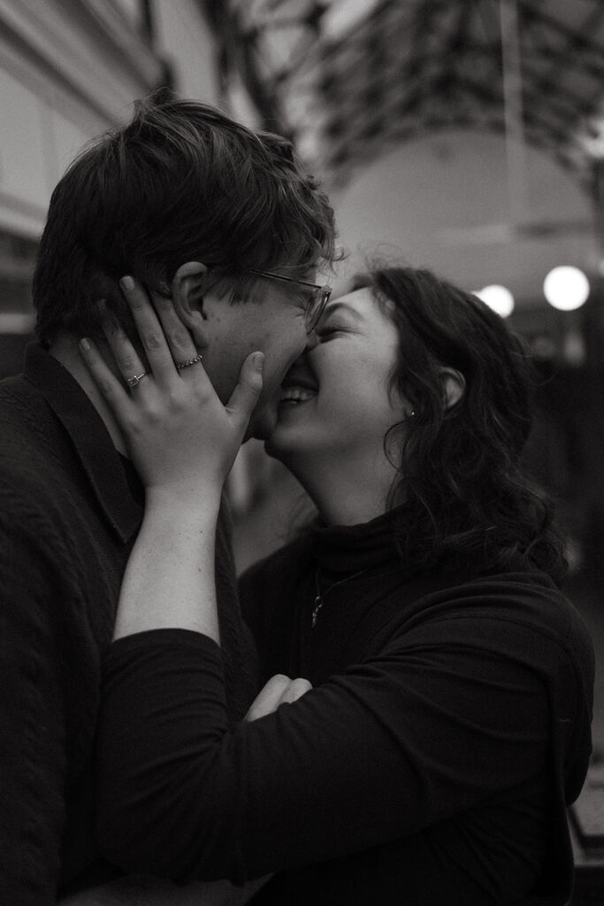 Cinematic engagement photos with quirky engaged couple nuzzling noses in downtown Nashville