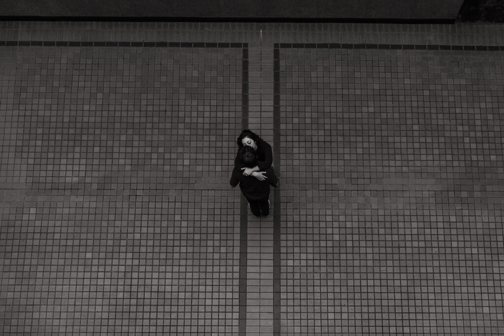 Bird's eye view of engaged couple kissing below in The Arcade in downtown Nashville