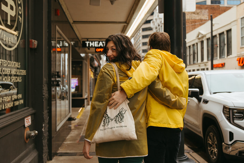 Cinematic engagement photos with Nashville couple walking through the rainy, New York-inspired streets of Nashville.