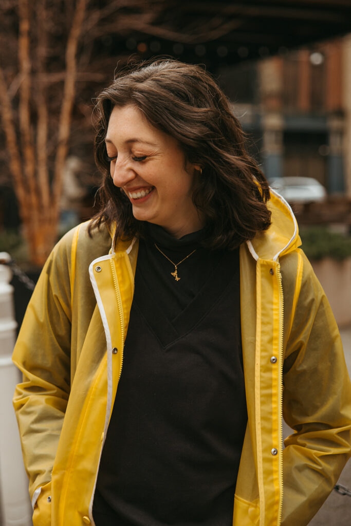 Cinematic engagement photo of woman wearing yellow rainjacket