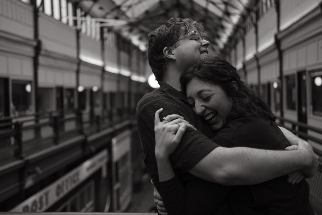 Man envelopes fiance in a bear hug as they stand in the Arcade in downtown Nashville