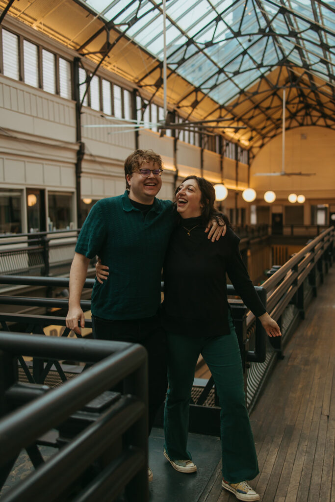 Woman looks lovingly at fiance as they walk through the Arcade in downtown Nashville