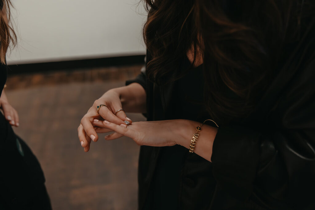 Woman plays with her engagement ring in LGBTQIA+ proposal photos in downtown Nashville