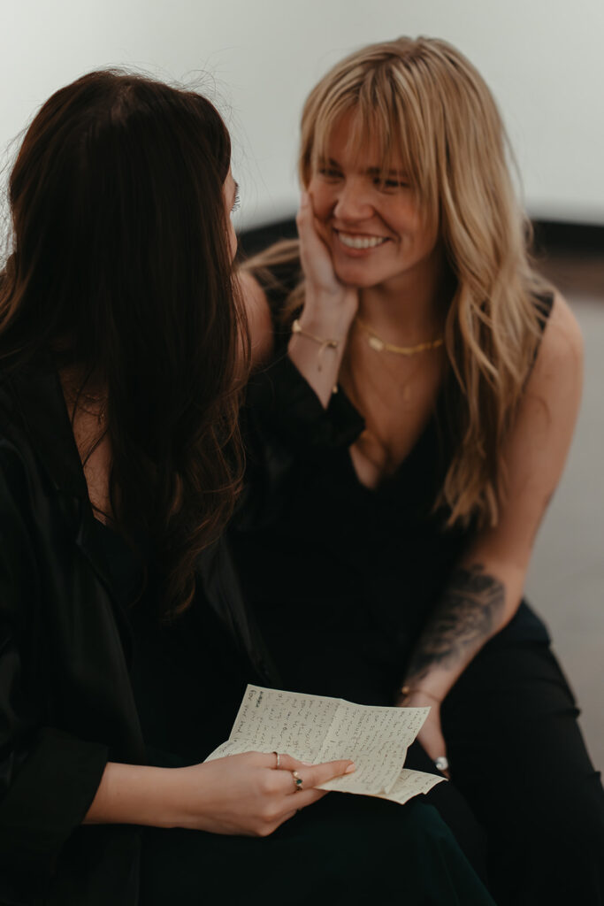 Couple looks into each other's eyes while reading a letter