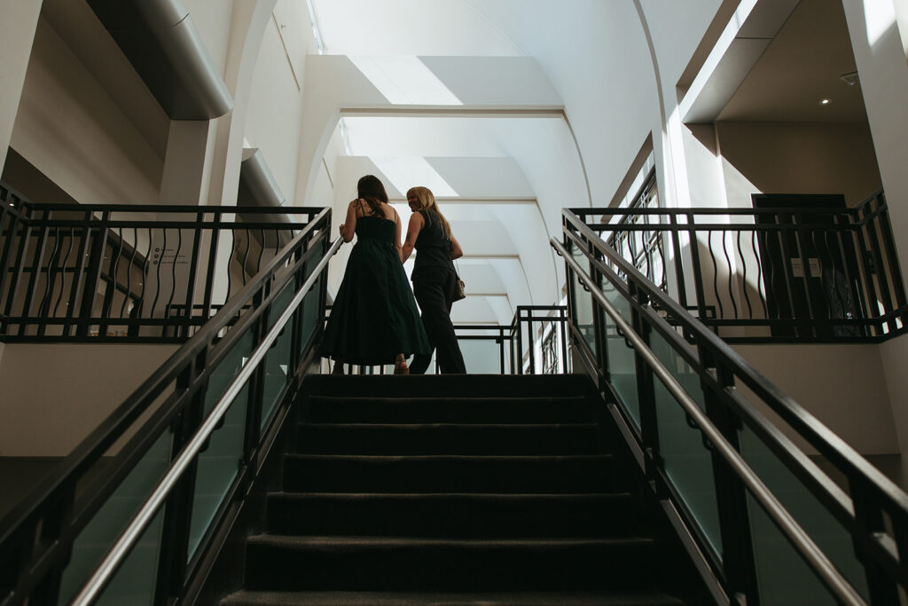Engaged women walk hand in hand during Nashville proposal photos