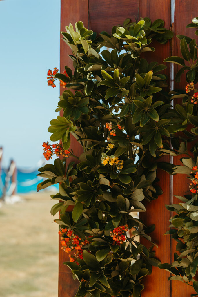 Gorgeous greenery and small blooms on door at destination wedding in Mexico