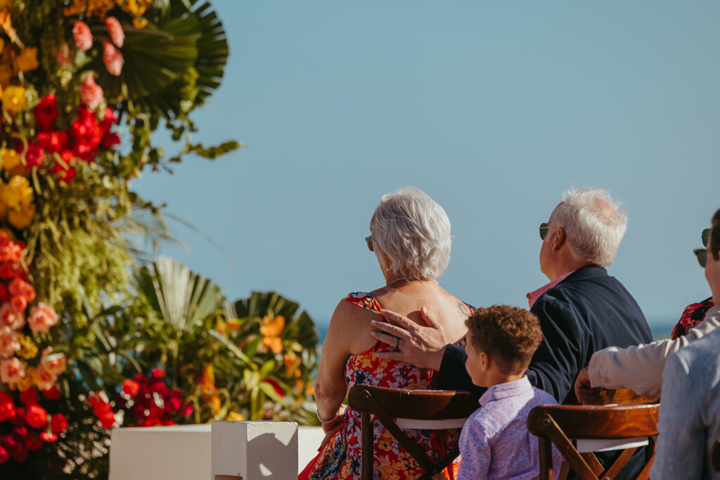 Wedding guests watch the ceremony in adoration