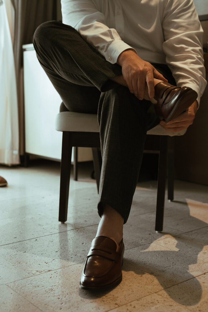 Groom puts his shoes on