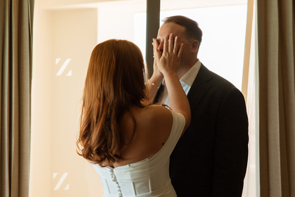 Bride wipes the tears from her groom's face