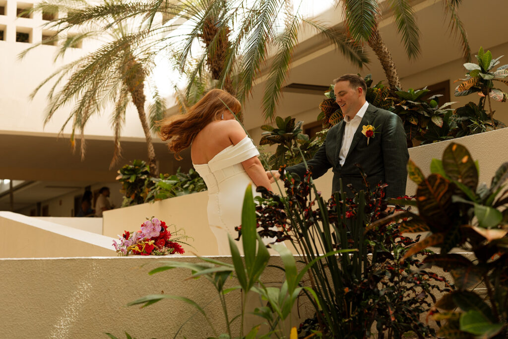 Groom takes in his bride during first look at Hyatt Ziva Cancun destination wedding in Mexico