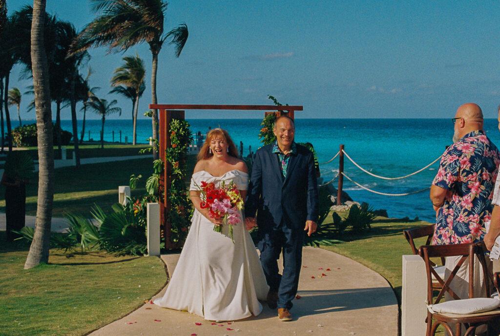 Bride's elation is written all over her face as she is escorted down the aisle by her father