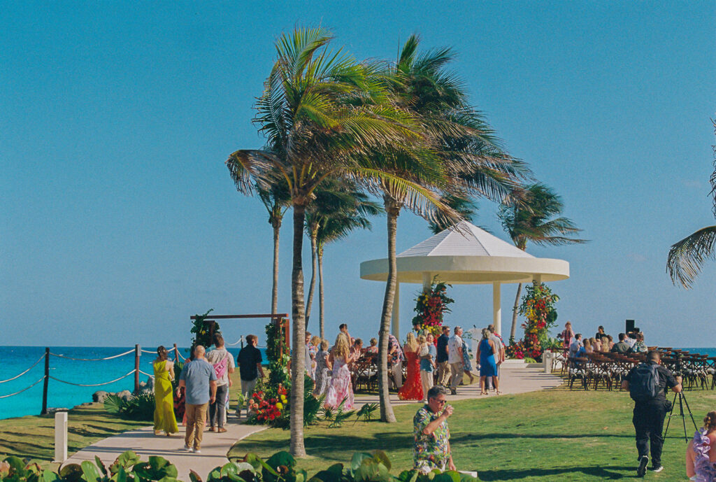 Guests mingle outside Mexico destination wedding ceremony