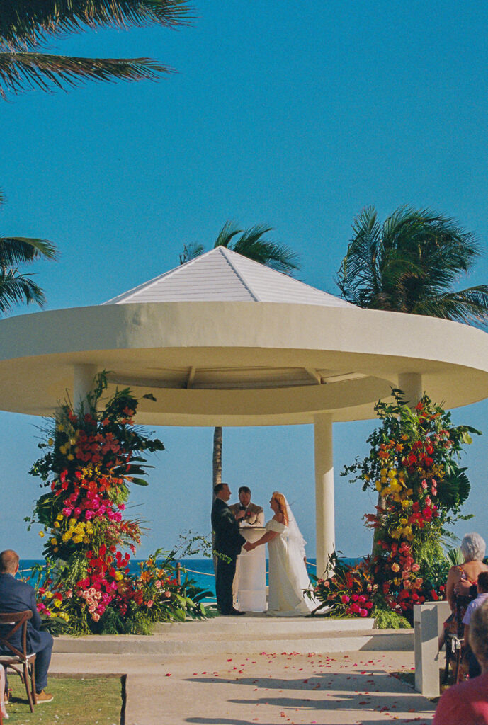 Bride and groom stand hand in hand at destination wedding in Mexico