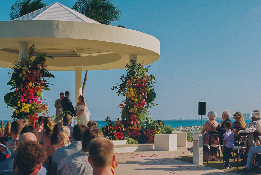 35mm of bride and groom exchanging vows overlooking the water at destination wedding in Mexico