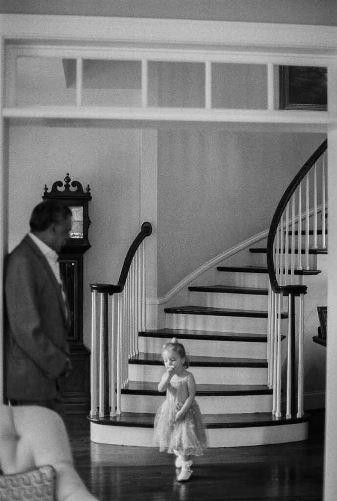Young girl walking toward a spiral staircase inside the home