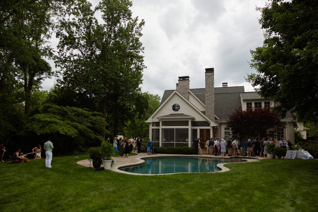 Guests gathered around the pool for a casual backyard wedding reception in Tennessee