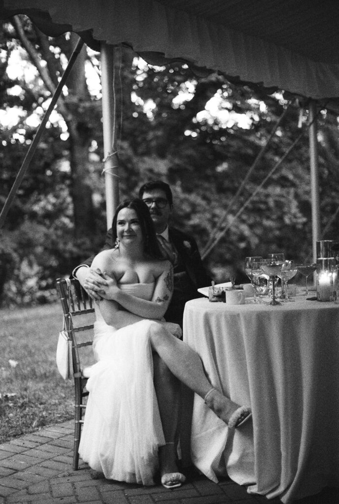 Film wedding photography of bride and groom listening to speeches