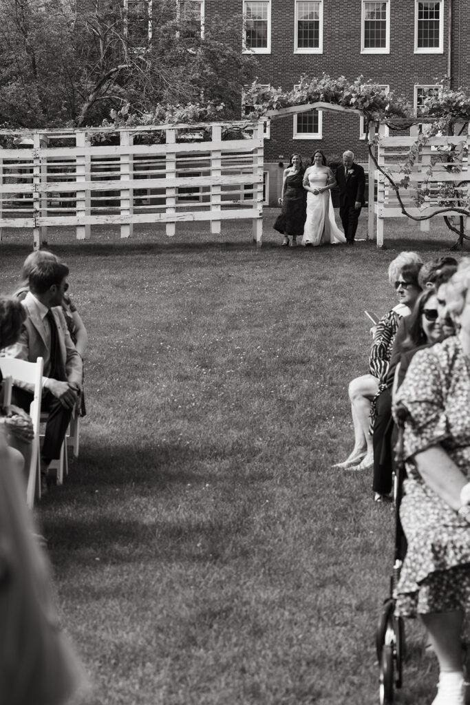 Film wedding photography of bride and parents coming down the aisle in Tuscan-coded wedding