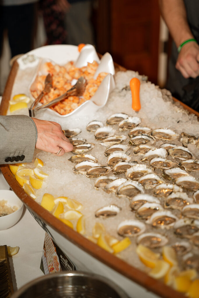 Oyster bar on ice, accented with lemon wedges and seafood details.