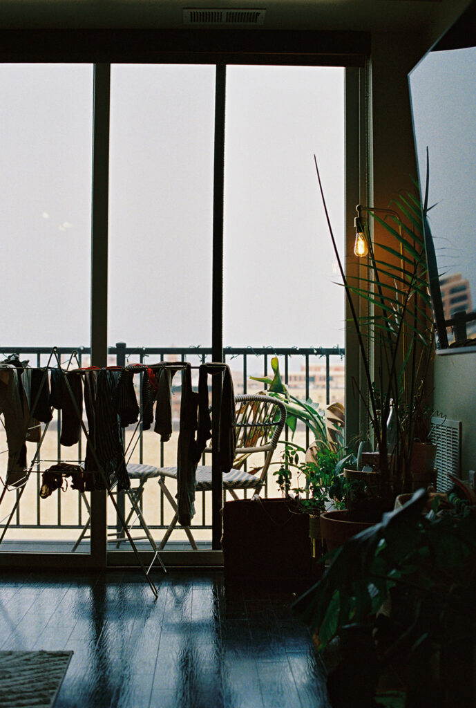 Balcony view with clothes hanging, cinematic detail from a Minneapolis engagement session.