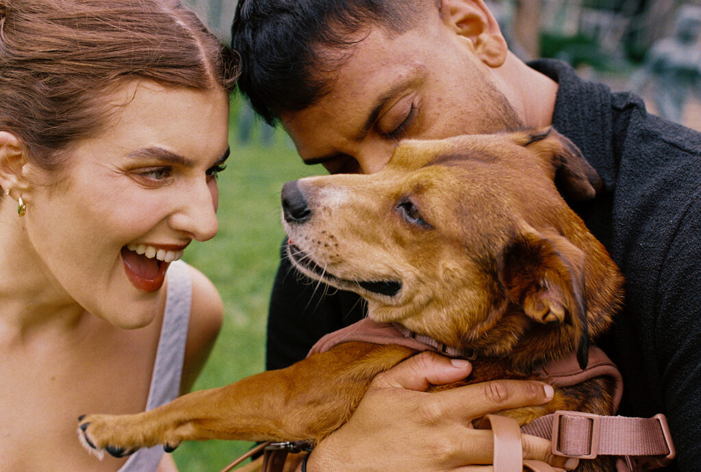 Couple cuddling with their dog Pip in Minneapolis engagement photography