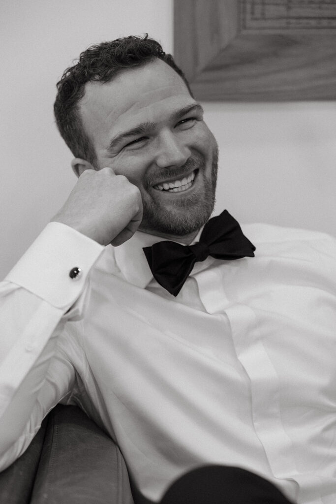 Groom portrait mid-smile—proof playfulness photographs better than perfection.