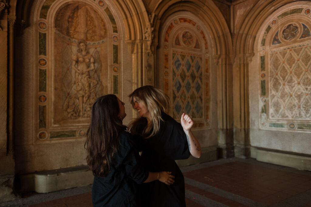 A couple dances under the historic tiled ceiling of Bethesda Terrace, wrapped in golden light during their New York city wedding proposal photos.