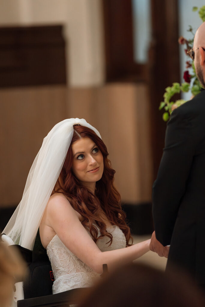 Bride peers up through her lashes at her husband once she reaches the altar