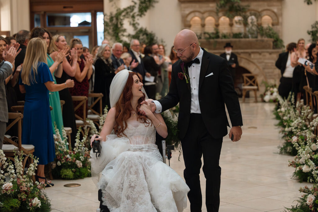 Fiona Cauley and husband walk down the aisle after saying their vows at Union Station in Nashville. 