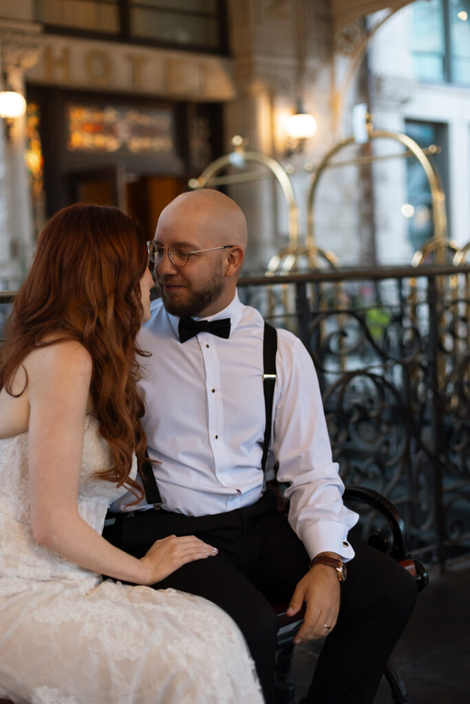 Groom looks at his bride in awe as they share a quiet moment outside Union Station in Nashville