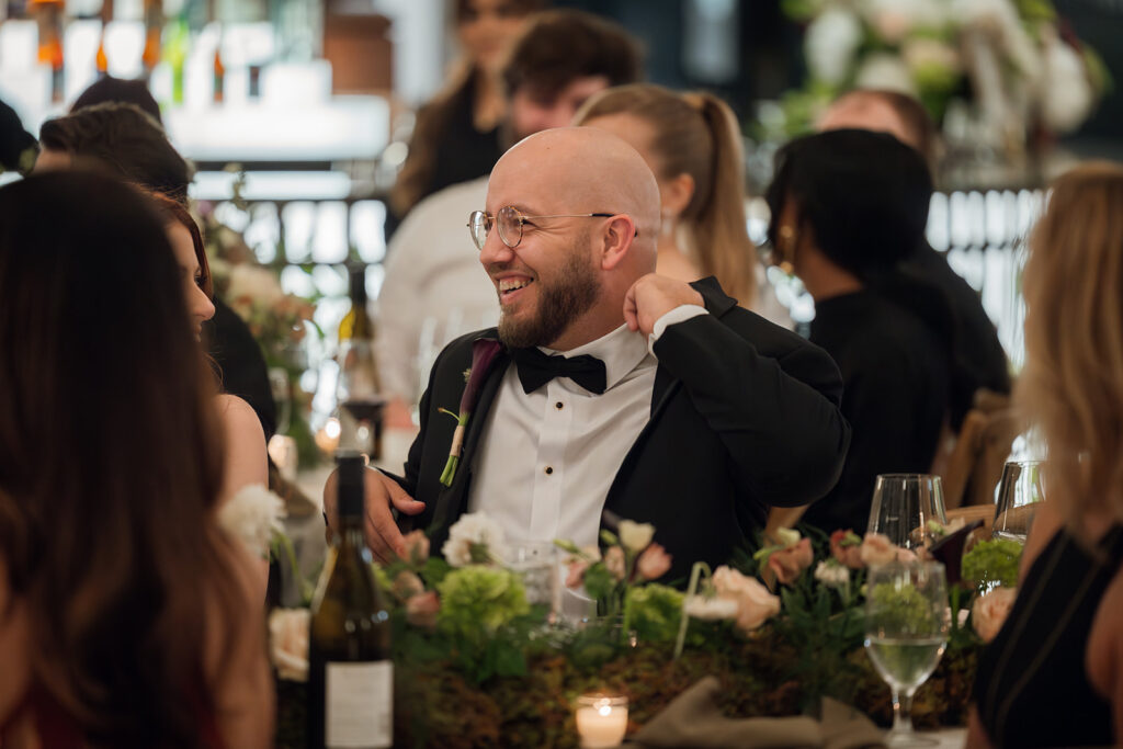 Groom laughs uncomfortably as best man roasts him during a speech
