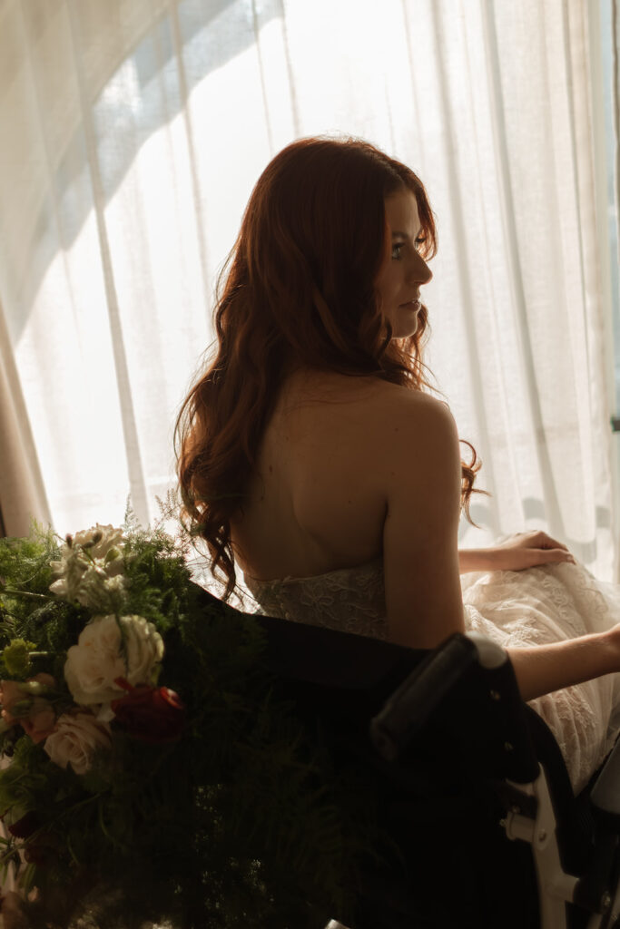 Comedian Fiona Cauley on her wedding day at Union Station in Nashville, captured in the early morning glow through the gauzy curtains.