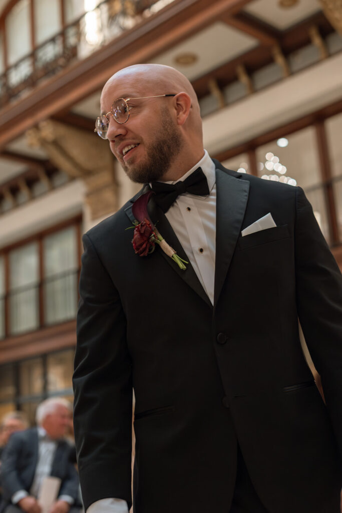 Groom wears expression of sheer disbelief as he waits for his bride to make her way towards him during their Nashville wedding at Union Station.