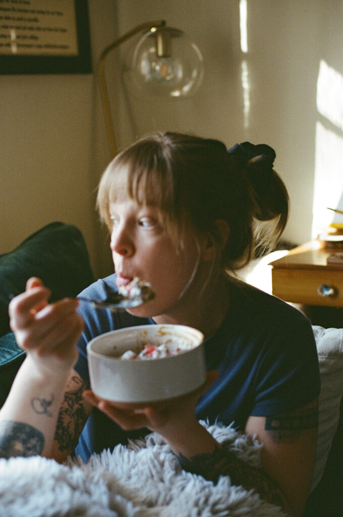 Candid photograph of Nashville photographer Ali Miller eating her hyperfixation breakfast during a quiet morning at home.
