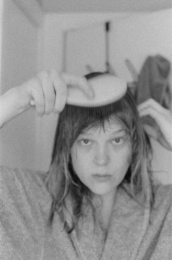 Nashville photographer Ali Miller brushes her bangs after a shower during documentary-style branding photos capturing her everyday morning routine.