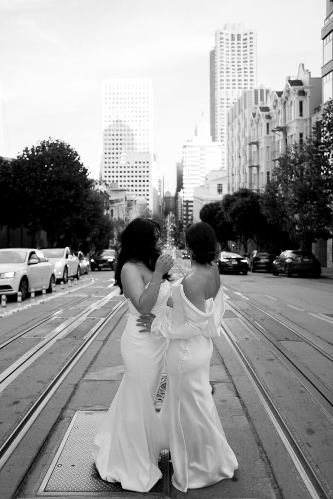 Two brides stand in the middle of San Francisco in emotional editorial wedding photograph
