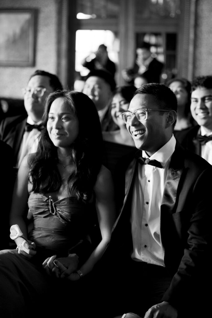 Wedding guests listen and laugh during vows at San Francisco wedding for lesbian brides